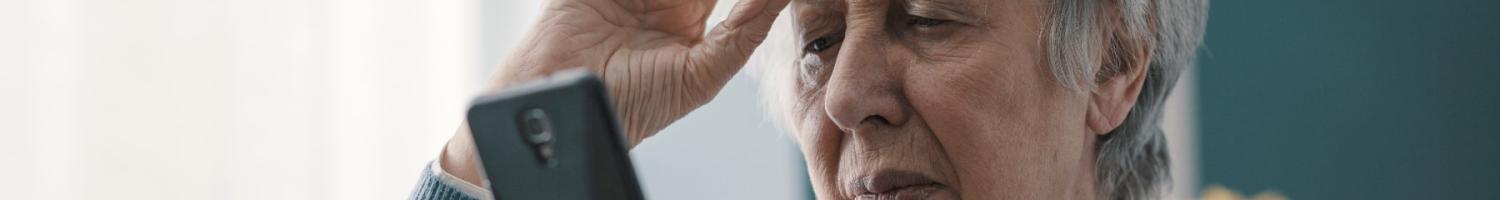 Photo of older woman looking at a smartphone display