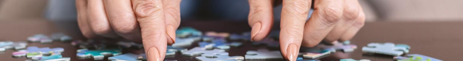 Photo of an older woman working on a jigsaw puzzle