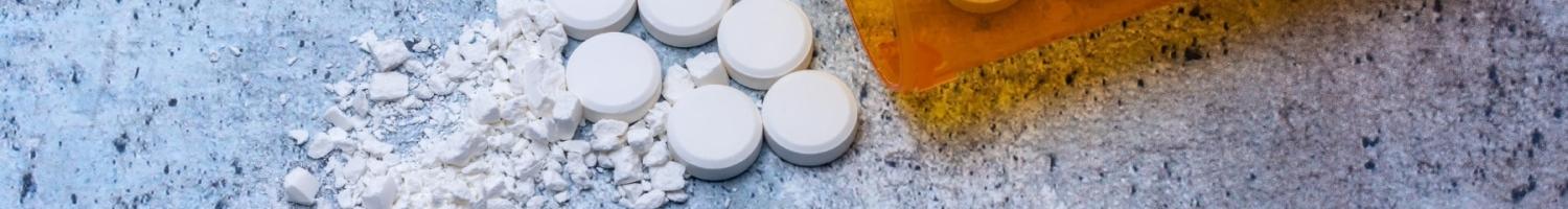 Photo of crushed pills on a mottled surface