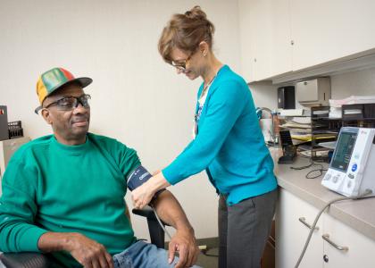 Man getting blood pressure checked by a nurse