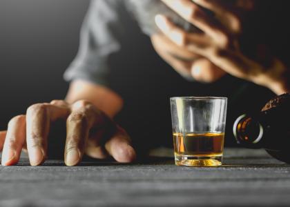 Photo of shot of liquor and man's hand