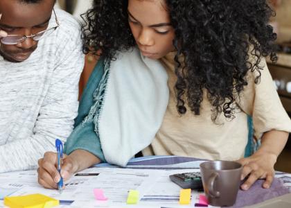 Photo of Black couple reviewing financial documents 