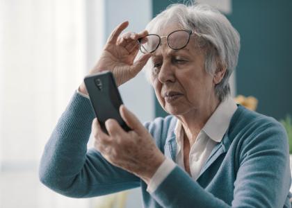 Photo of older woman looking at a smartphone display